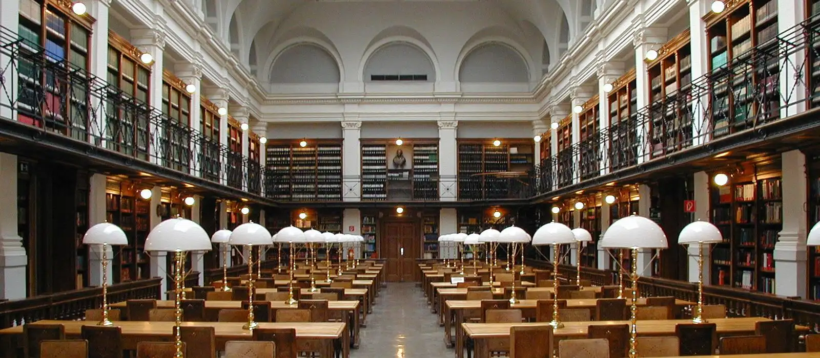 Lesesaal einer Universitätsbibliothek mit Bücherregalen und Lesetischen